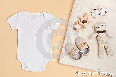 Mockup of white infant bodysuit made of organic cotton with eco friendly baby accessories Stock Photo