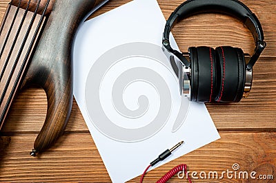 Mockup with a white sheet of paper with a guitar and headphones for music themes and drawings Stock Photo
