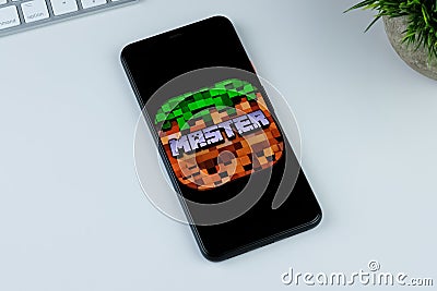 MOD-MASTER for Minecraft PE Pocket Edition app logo on a smartphone screen. Editorial Stock Photo