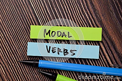 Modal Verbs write on sticky notes isolated on office desk Stock Photo
