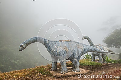 Model of Chiang Muang dinosaur with mist at Phayao province Editorial Stock Photo