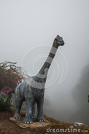 Model of Chiang Muang dinosaur with mist at Phayao province Editorial Stock Photo