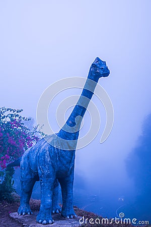 Model of Chiang Muang dinosaur with mist at Phayao province Editorial Stock Photo