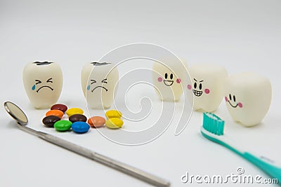 Model Cute toys teeth and colorful candy in dentistry on a white background Stock Photo