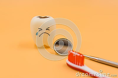 Model Cute toys teeth in dentistry on a yellow background Stock Photo