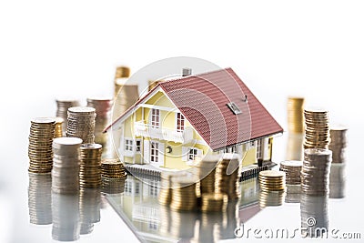 Model familly house with coins as bank or insurance concept Stock Photo