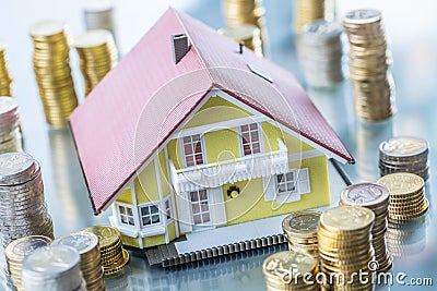 Model familly house with coins as bank or insurance concept Stock Photo