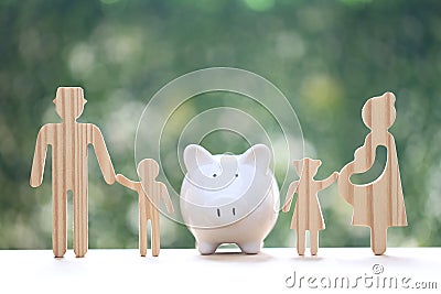 Model family with piggy bank and stack of coins money on natural green background,Save money for prepare in future and family Stock Photo