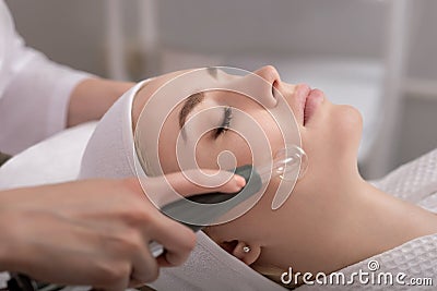 Model geting cleansing peeling rejuvenating facial treatment in a beauty SPA salon Stock Photo