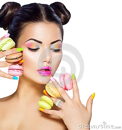 Model girl taking colorful macaroons Stock Photo