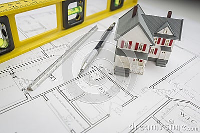 Model Home, Level, Pencil and Ruler Resting on House Plans Stock Photo
