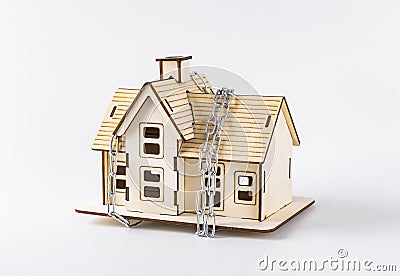 A model of a house bound with chains Stock Photo