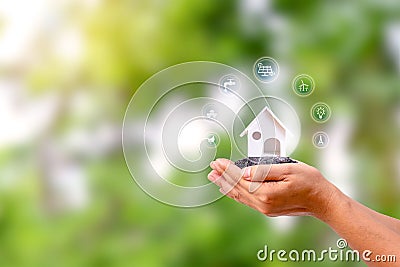 Model house with energy icon in a human hand, energy-saving Stock Photo