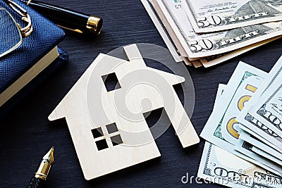 Model of house and money. Real estate investment. Stock Photo