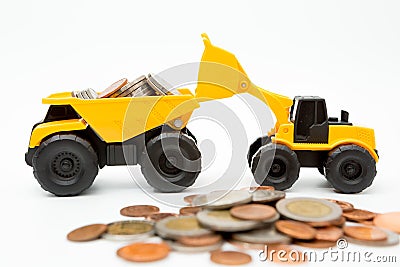 Model loader, Dump truck, coins stack on white background for money saving concept Stock Photo