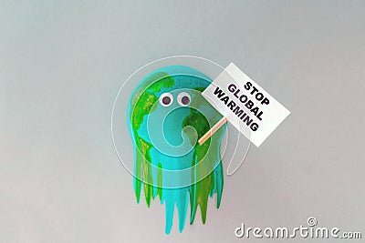 Model of planet Earth melts and holds a stop global warming sign Stock Photo