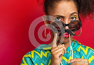 Model plays with cardboard mustache Stock Photo