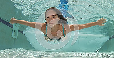 Model in a pool wearing a mermaid`s tail. Stock Photo