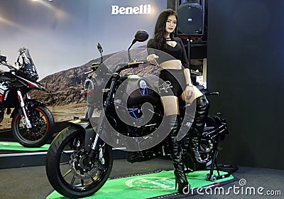 Model posed with Benelli Leoncino Trail 500cc scrambler, displayed during the Kuala Editorial Stock Photo