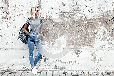 Model posing in plain tshirt against street wall Stock Photo