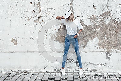 Model posing in plain tshirt against street wall Stock Photo