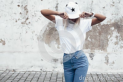 Model posing in plain tshirt against street wall Stock Photo