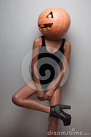 Model posing with pumpkin on head Stock Photo