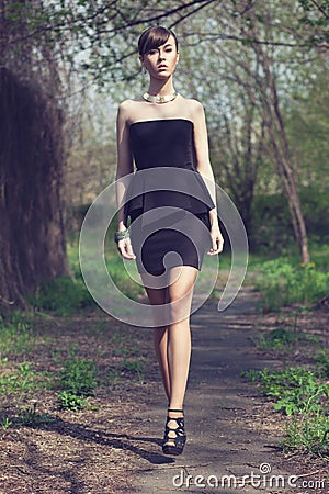 Model posing in short black dress Stock Photo