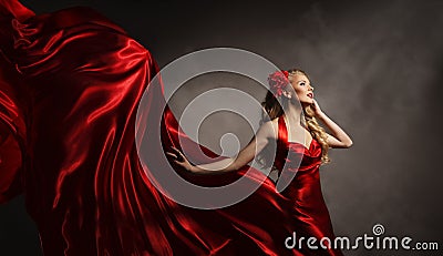 Model in Red Dress, Glamour Woman Posing Flying Silk Cloth Stock Photo