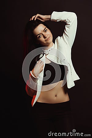 Model test with lovely tanned model in stylish jacket over a black studio background Stock Photo