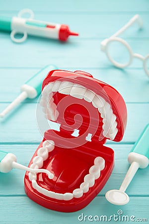 Model toys teeth with dentist instrument on blue background Stock Photo