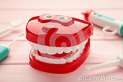 Model toys teeth with dentist instrument on pink background Stock Photo