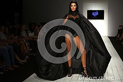 A model walks runway in designer swim apparel during the Furne Amato fashion show Editorial Stock Photo