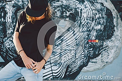 Model wearing plain tshirt and sunglasses posing over street wall Stock Photo