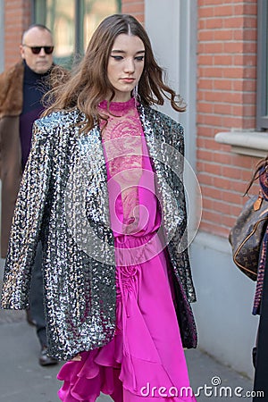 Model wears a fuchsia dress, a silver jacket and python socks Editorial Stock Photo