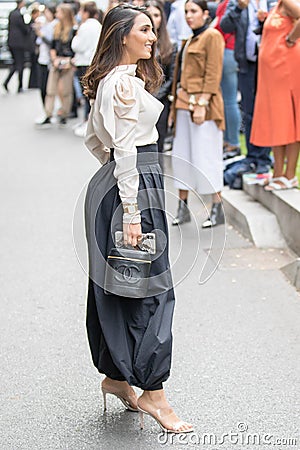 Model wears a pair of gray trousers, an unlocked blouse, a Gucci bag and a pair of beige heeled shoes Editorial Stock Photo