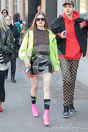 Model wears a shiny black miniskirt and a Fendi shirt Editorial Stock Photo