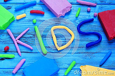 Modelling clay of different colors forming the word kids Stock Photo