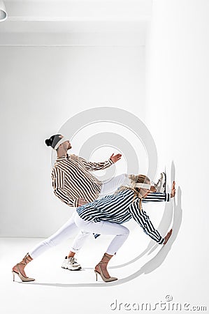 Models wearing blindfolds posing for creative gravity photo session Stock Photo