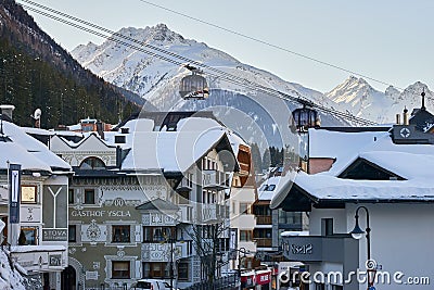 Modern aerial tramway in Austrian Alps ski resort. Highland cable car leads between hills from village to ski slope. Editorial Stock Photo