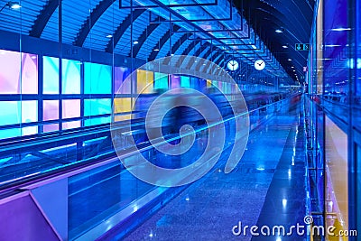 Modern airport moving walkway indoor with travelers. Transport corridor Stock Photo