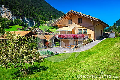 Modern alpine wooden house with orderly garden in Switzerland Stock Photo