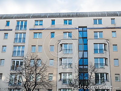 Modern Apartment Building with Bare Trees Stock Photo