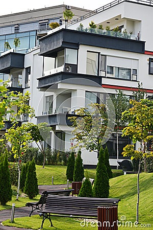 Modern apartments building, with garden, bushes and trees, portrait image Stock Photo