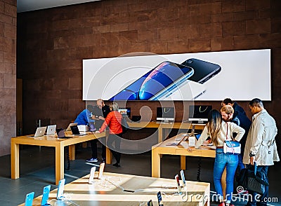 Modern Apple Store with customers shopping Editorial Stock Photo