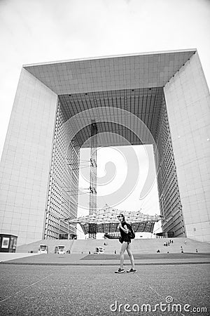 Modern architecture. Backpacker exploring city. Summer vacation. Woman stand in front of urban architecture. Must visit Stock Photo