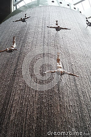 Waterfall with divers for pearls in the Dubai Mall. United Arab Emirates. Editorial Stock Photo