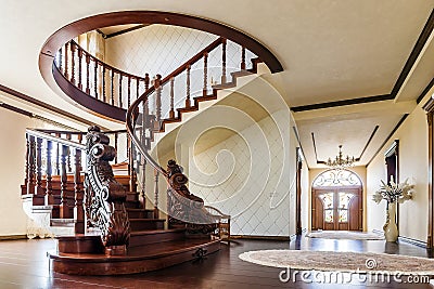 Modern architecture interior with classic elegant luxury hallway with curved glossy wooden staps stairs in modern storey house Stock Photo