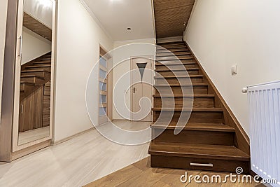 Modern architecture interior with elegant luxury hallway with glossy wooden staps stairs in modern storey house Stock Photo