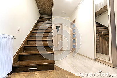 Modern architecture interior with elegant luxury hallway with glossy wooden staps stairs in modern storey house Stock Photo